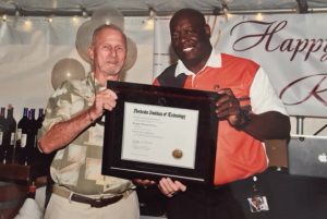 Bob Fitch, left, recieves his diploma from RIT's Howard Ward.