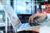 Hacker, laptop and hands with credit card information typing data with digital cybersecurity overlay for information technology. Hacking, cyberpunk and futuristic software expert phishing and malware.