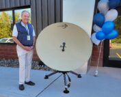 Robert Jacobson, Lite Com’s president and CEO, stands next to one of the company’s products outside its new 20,000-square-foot building in Victor. (Photo by Andrea Deckert)