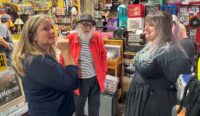 Assemblymember Sarah Clark speaks with Record Archive owners Richard and Stormy Storms. (Photo provided by Assemblymember Clark's office)