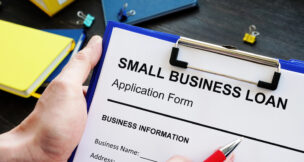 Small business loan paper on clipboard by Depositphotos