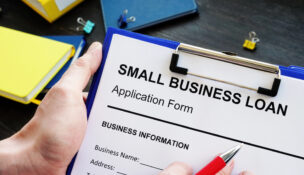 Small business loan paper on clipboard by Depositphotos