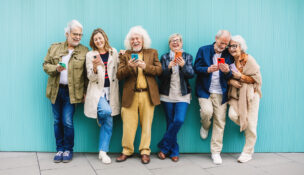 seniors lined up in front of light blue wall by Depositphotos