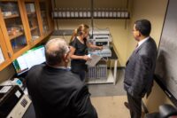 Tara Sweet, SUNY Geneseo assistant professor, explains lab equipment to Kodak’s Jim Continenza and SUNY Chancellor John B. King Jr. (SUNY Geneseo photo)
