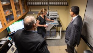 Tara Sweet, SUNY Geneseo assistant professor, explains lab equipment to Kodak’s Jim Continenza and SUNY Chancellor John B. King Jr. (SUNY Geneseo photo)