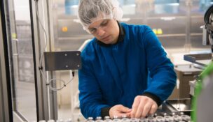 Bausch + Lomb technician Jacob DeHond performs maintenance on robotic manufacturing equipment in Rochester. (Photo provided by Bausch + Lomb)