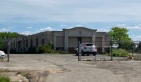 Syracuse-based Erie Materials intends to demolish the condemned hotel property at 911 Brooks Ave. and build a new warehouse and showroom. (Photo by Kevin Oklobzija)