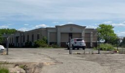 Syracuse-based Erie Materials intends to demolish the condemned hotel property at 911 Brooks Ave. and build a new warehouse and showroom. (Photo by Kevin Oklobzija)