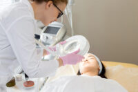 health care provider treating a patient by Depositphotos
