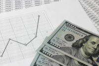 line graph with $100 bills by Depositphotos