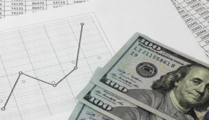 line graph with $100 bills by Depositphotos